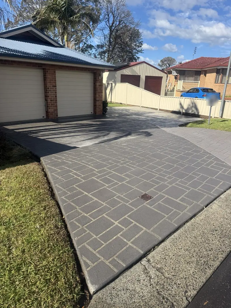 Faded stamped concrete driveway with pale grout lines
