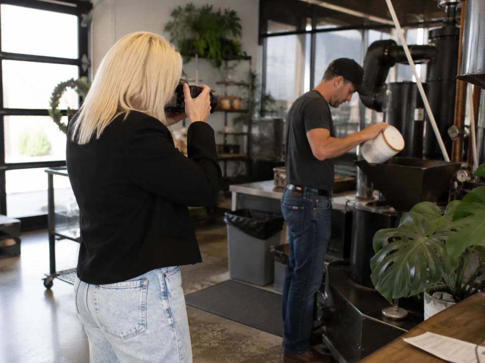 Camera operator capturing a coffee roasting demonstration on location