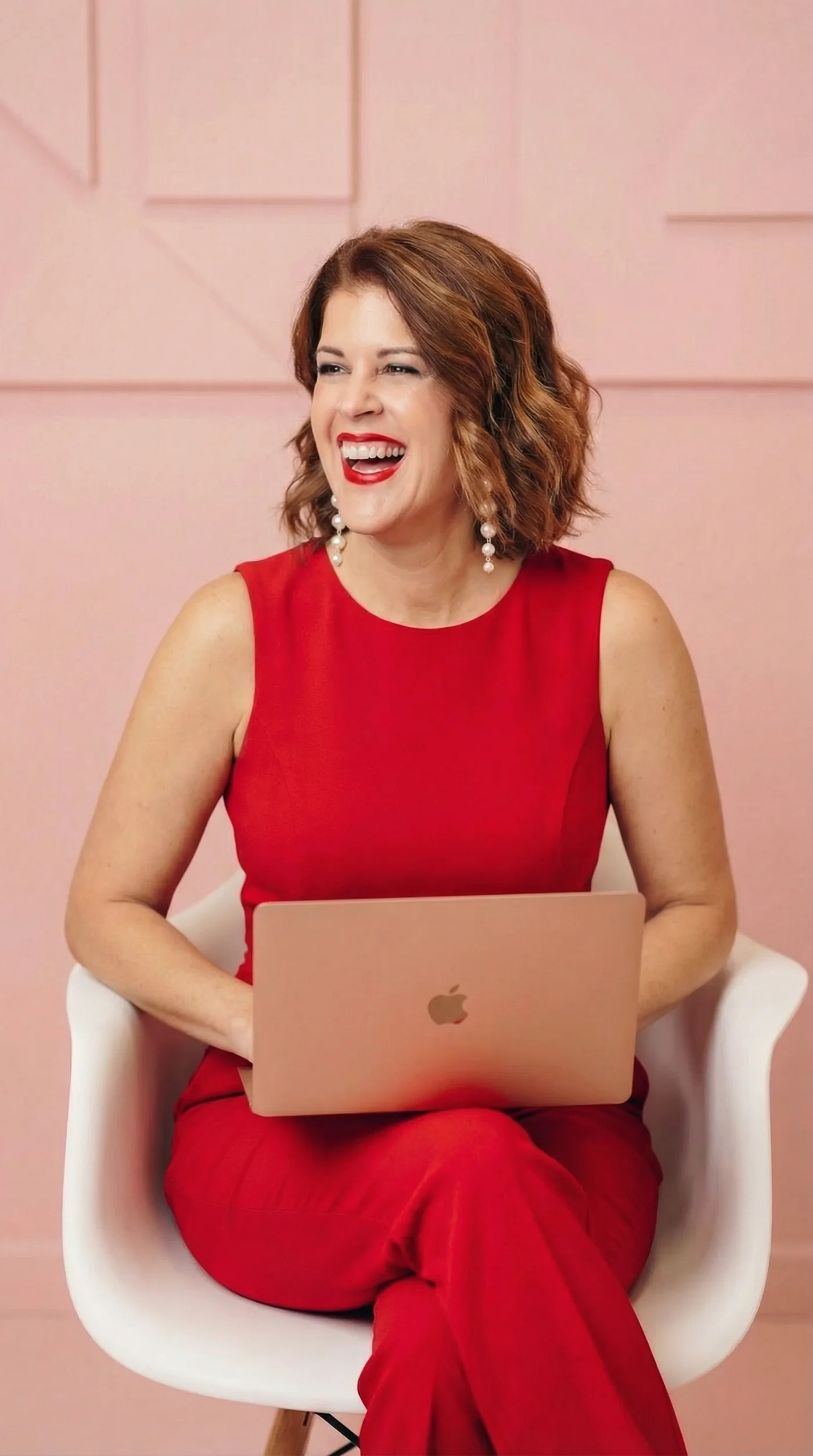 Laurel Beard in red with her laptop