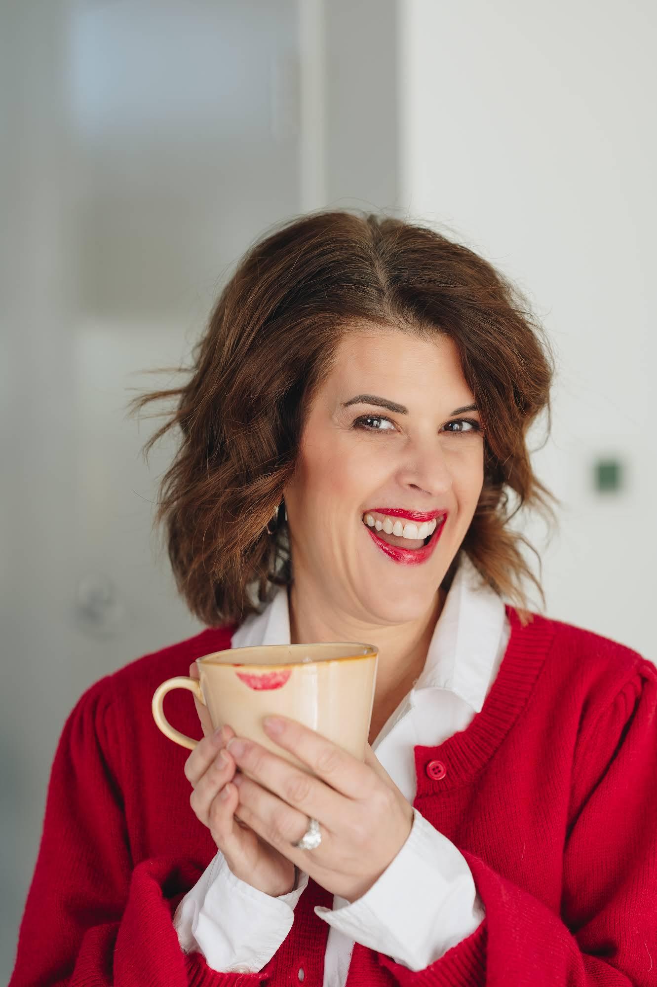 Laurel Beard laughing with a mug of coffee
