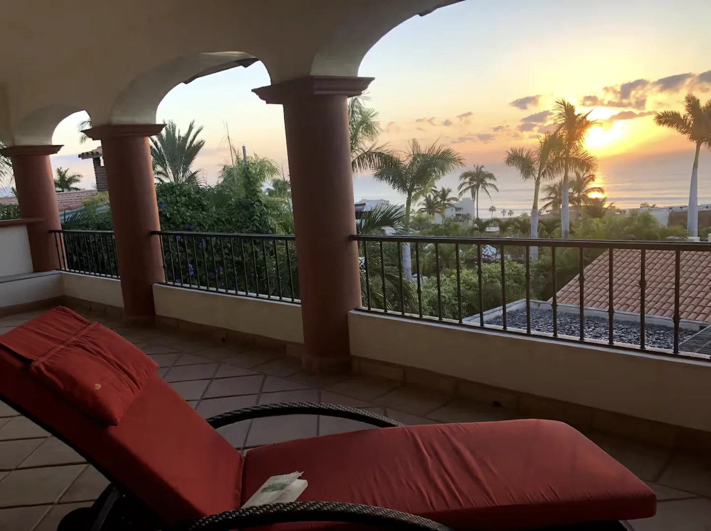 Sunset from Casa Alba's arched terrace over the palms
