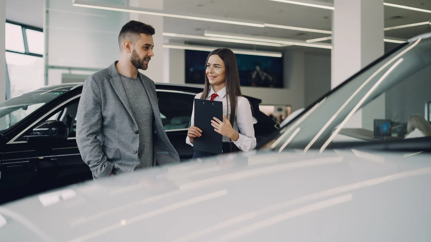 A shopper talking through vehicle options with an adviser