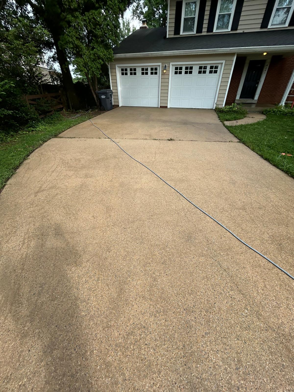 Concrete driveway after pressure washing, clean and even