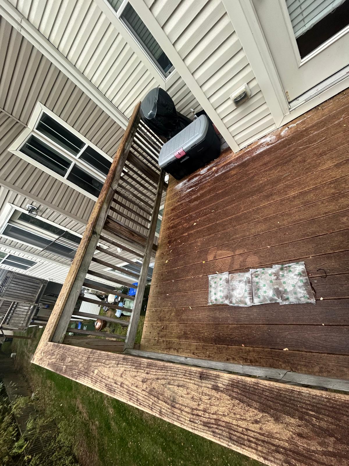 Wood deck before cleaning, weathered and gray