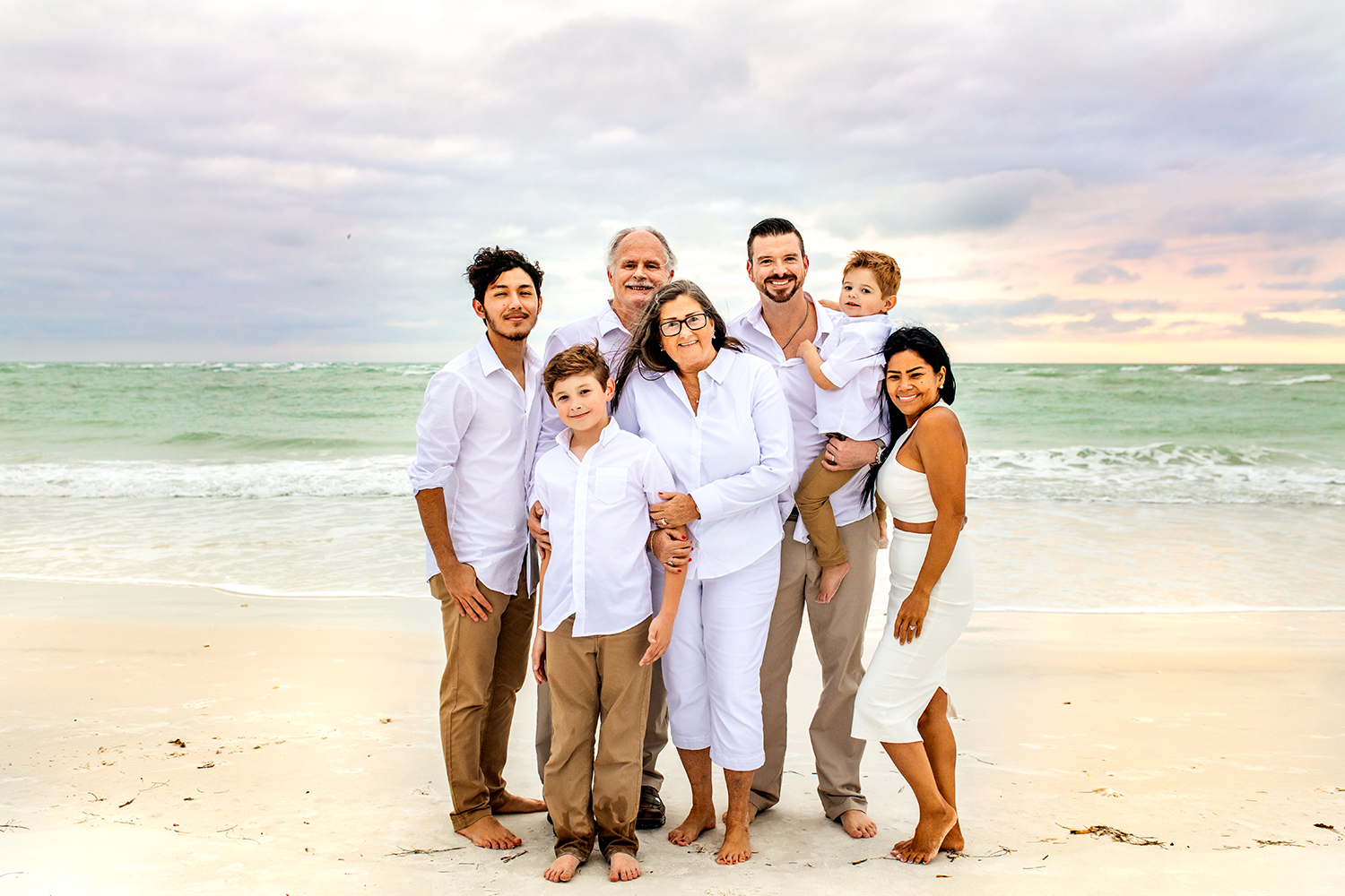 A family together on a Florida beach at sunset