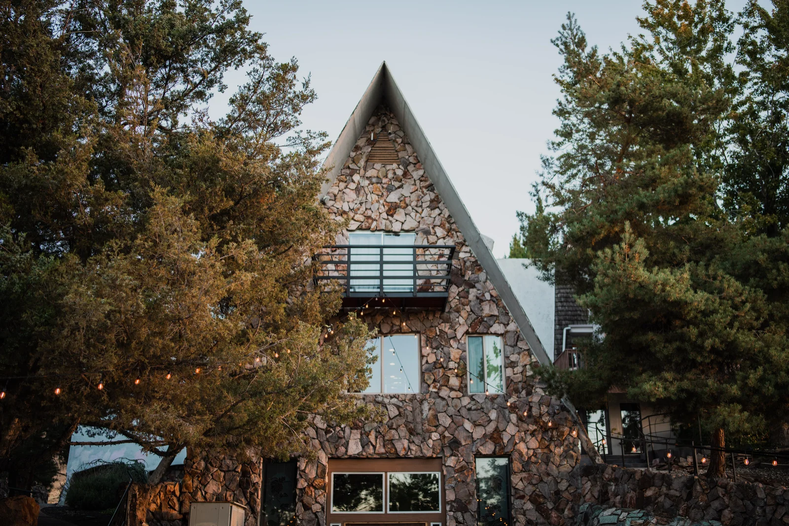 Stone architecture, framed by mature trees