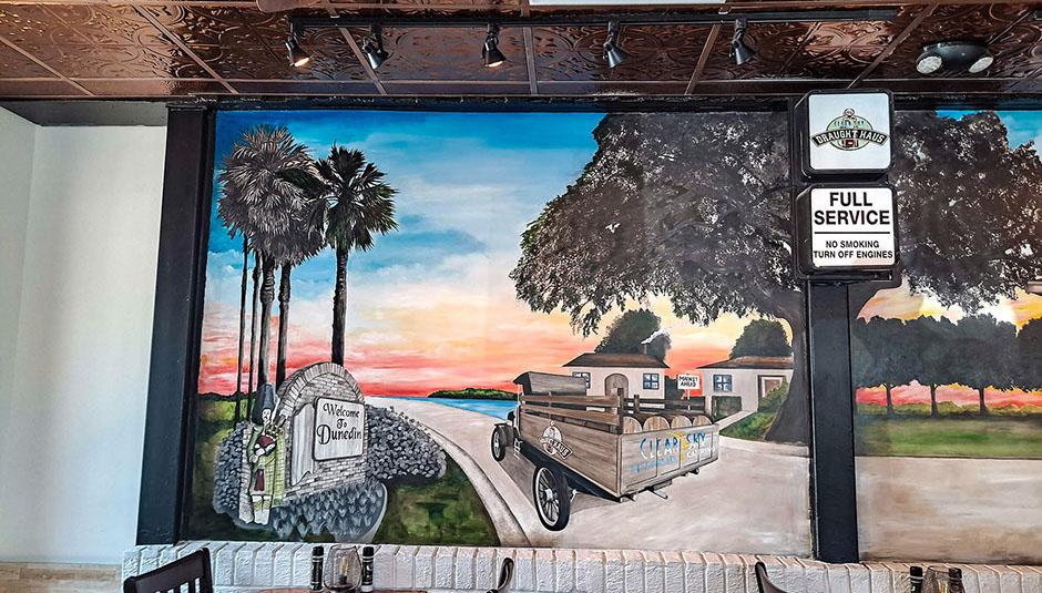 Mural of Florida palms under the pergola at Clear Sky Draught Haus