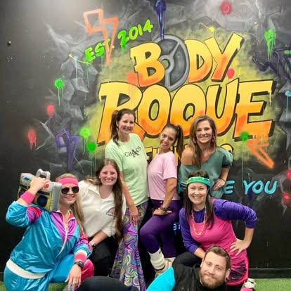 Members celebrating at the mural