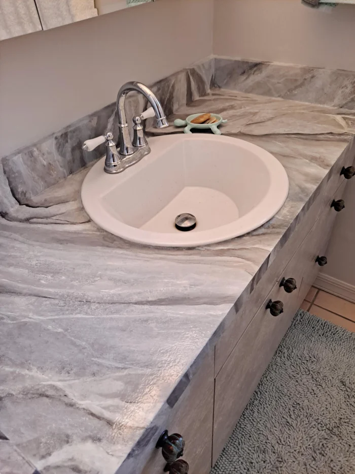 Faux stone finish surrounding a bath in a private home