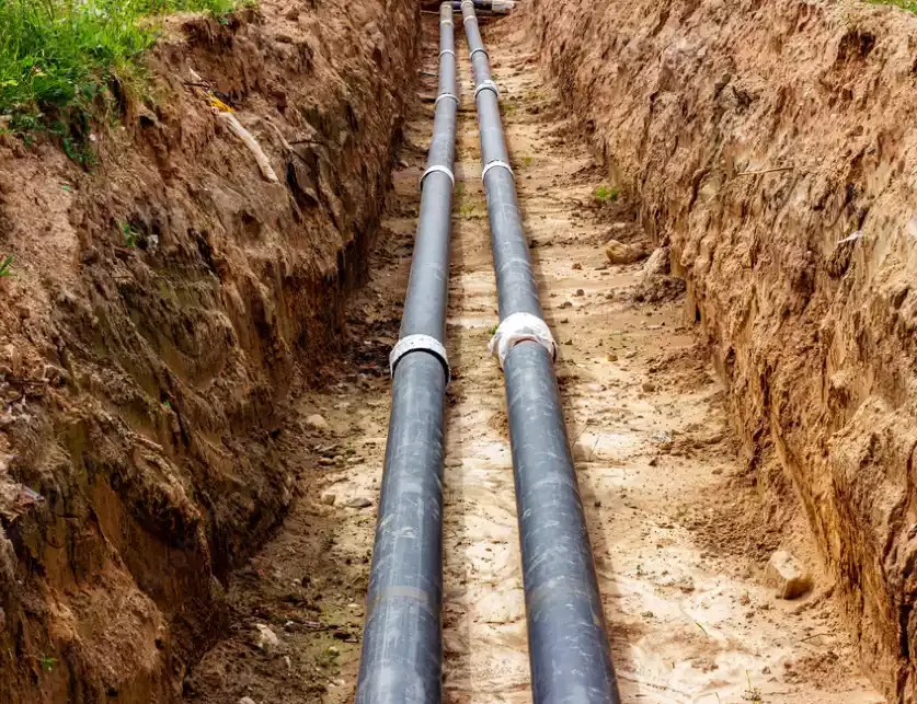 Buried sewer pipe exposed under a concrete slab