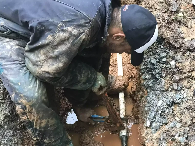 Water line repair underway in a muddy Atlanta trench