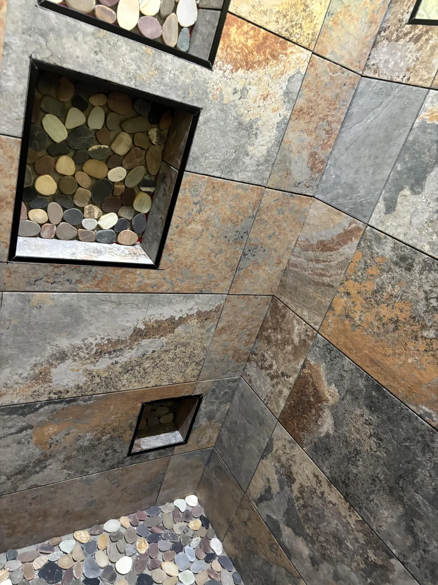 Decorative stone tile medallion shower detail