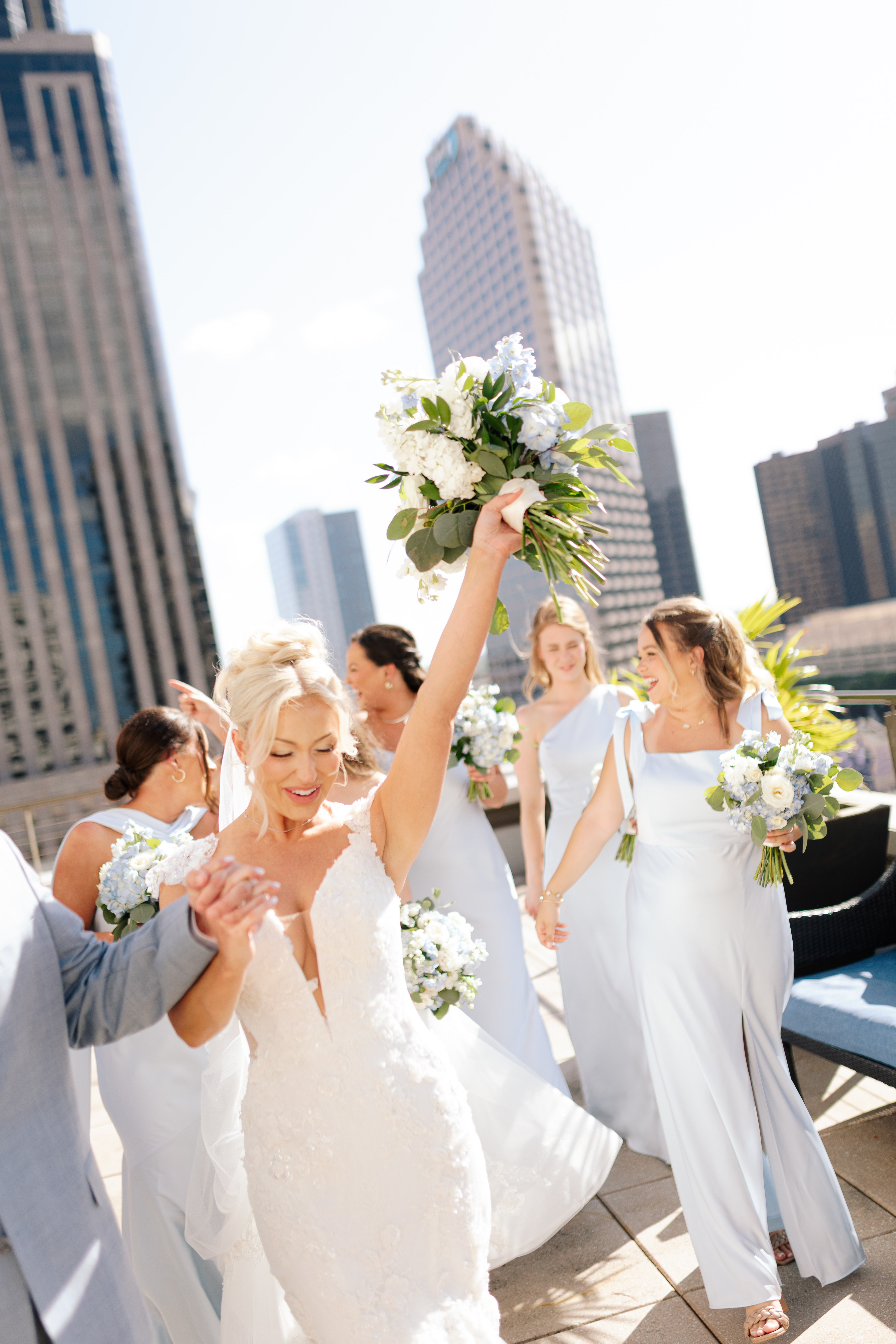 Bride celebrating with her bridesmaids on a rooftop in New Orleans