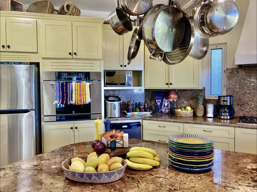Kitchen at Casa Alba with copper pots hanging above the island