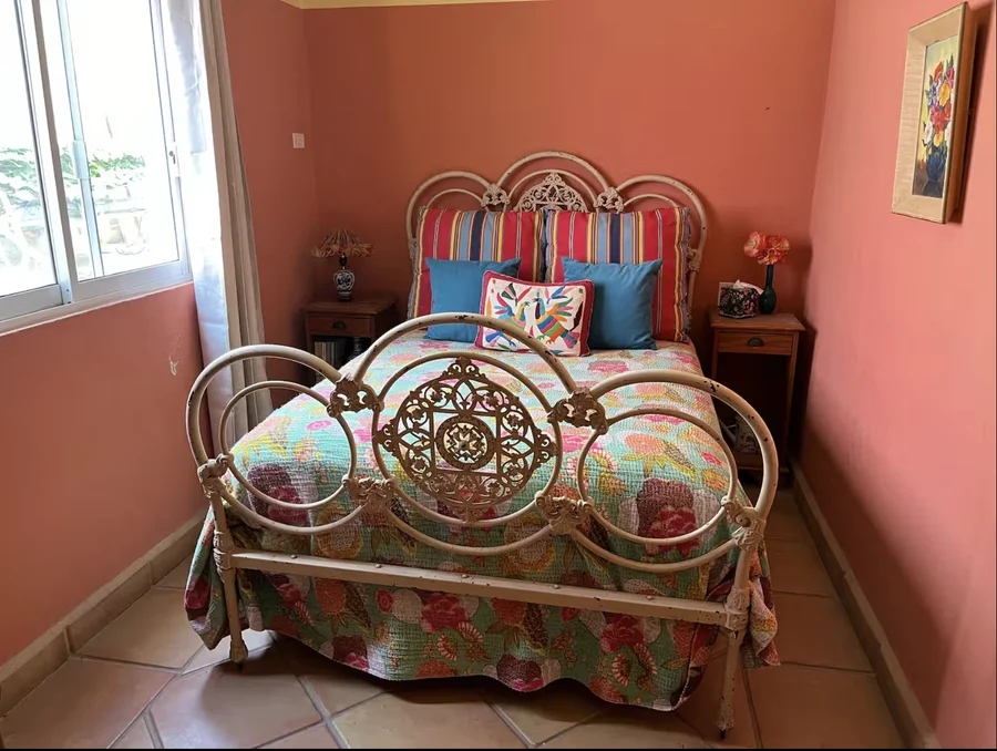 Bedroom at Casa Alba with an ornate iron bedframe