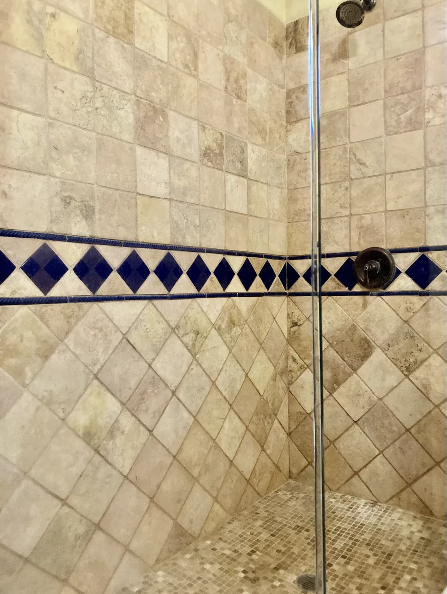 Shower at Casa Alba finished in stone and blue tile