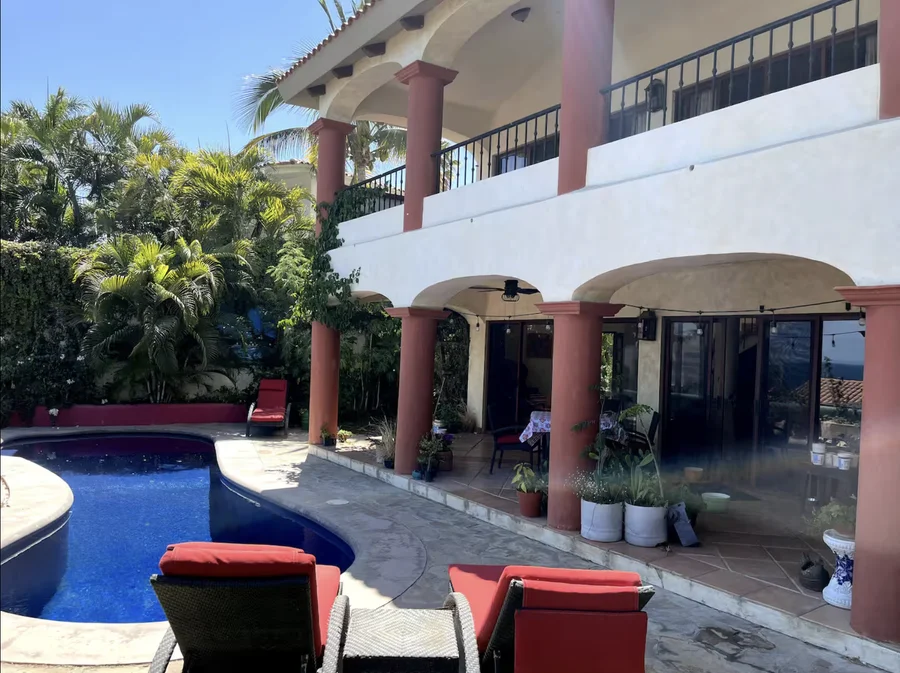 Shaded arcade beside the pool at Casa Alba