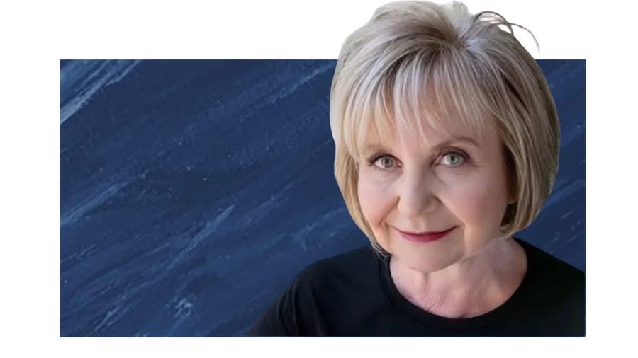 Dr. Cloe Madanes smiling in front of a dark blue marble background
