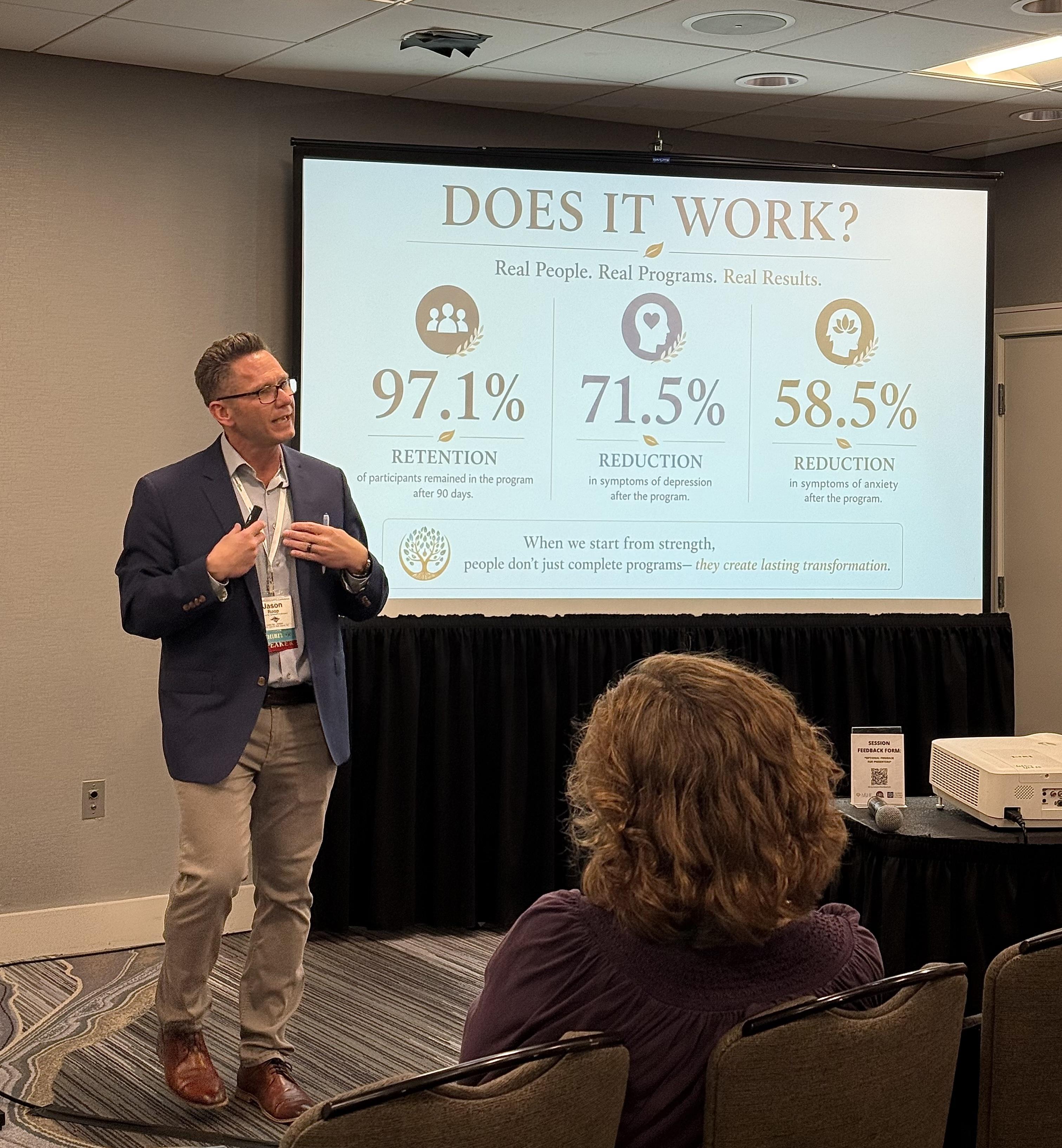 Jason Roop presenting Trait-Based outcomes at a professional conference