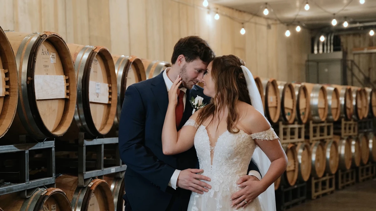 Cassidy and Dennis in the barrel room at Stone Tower Winery