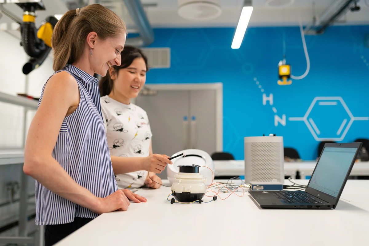 Engineers collaborating in an active workshop.