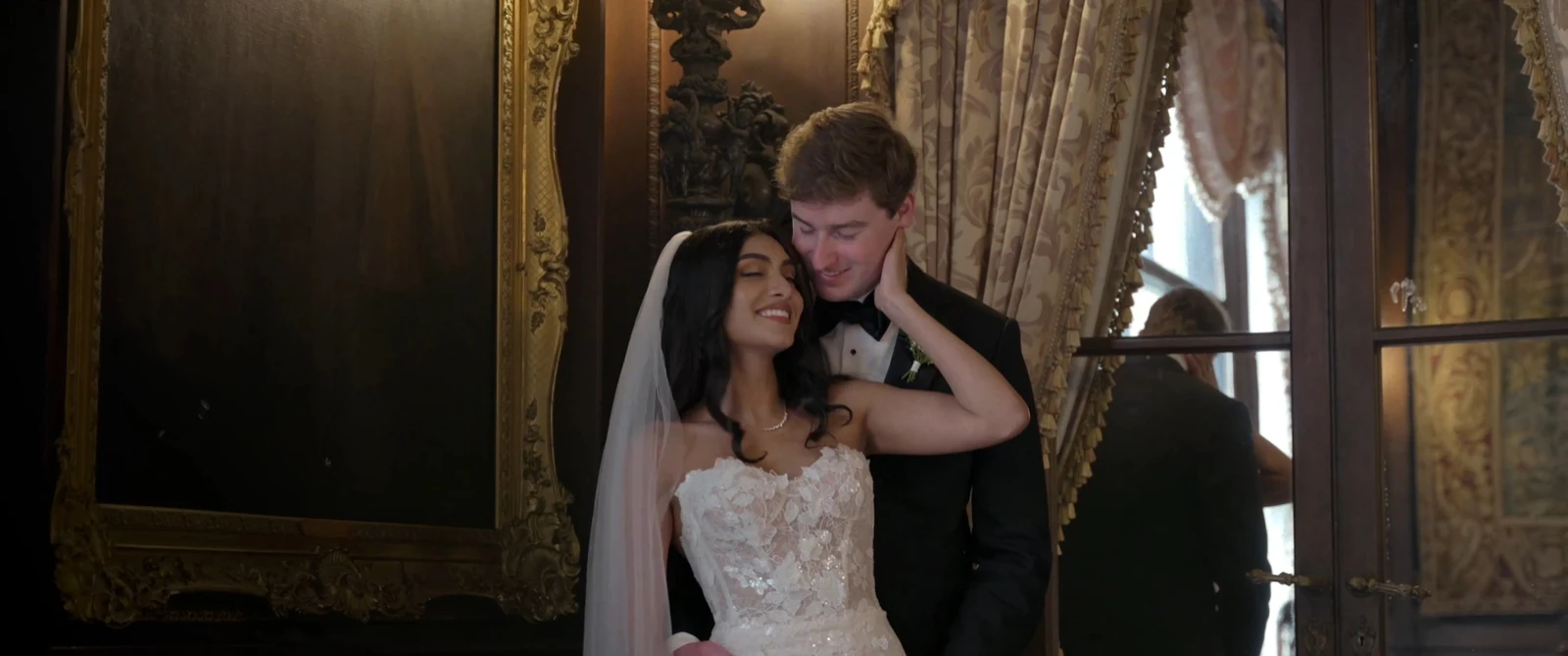 Aesha smiling as Ted kisses her temple at Larz Anderson House