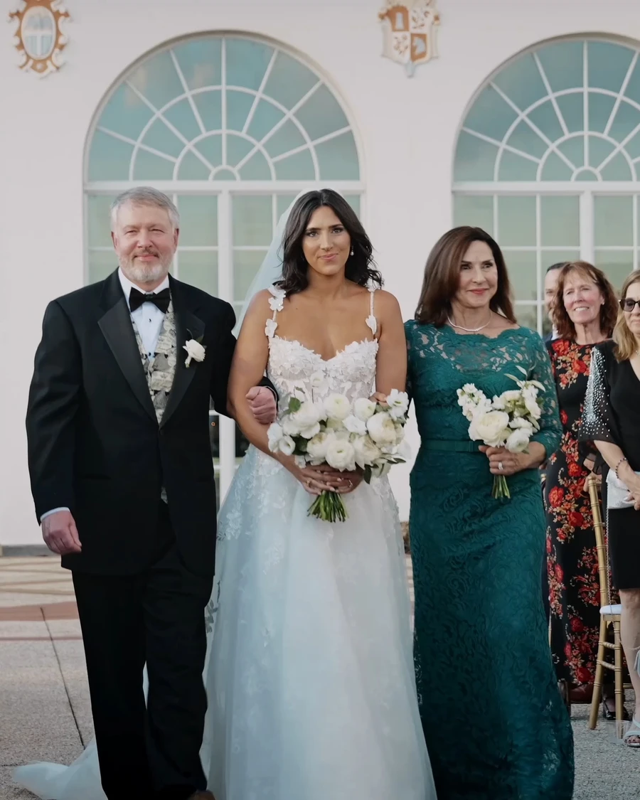 A bride walking down the aisle with her parents